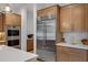 Close up of stainless steel refrigerator and oven with custom kitchen cabinets at 3929 E Bloomfield Pkwy, Gilbert, AZ 85296
