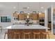 Spacious kitchen island with wooden stools and pendant lighting above at 3929 E Bloomfield Pkwy, Gilbert, AZ 85296