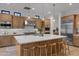 Gourmet kitchen with stainless steel appliances, custom cabinets and oversized island at 3929 E Bloomfield Pkwy, Gilbert, AZ 85296