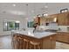 Well-lit kitchen featuring an island with barstool seating and modern pendant lighting at 3929 E Bloomfield Pkwy, Gilbert, AZ 85296