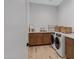 Well-lit laundry room featuring side-by-side washer and dryer and a modern tile floor at 3929 E Bloomfield Pkwy, Gilbert, AZ 85296