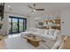 Open-concept living room with a large sectional sofa, modern ceiling fan, and backyard views at 3929 E Bloomfield Pkwy, Gilbert, AZ 85296