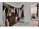Organized walk-in closet with drawers, shelves, and rods, next to a laundry area at 3929 E Bloomfield Pkwy, Gilbert, AZ 85296