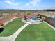 Aerial view of backyard with a sparkling pool, lush turf, and desert landscape at 4132 W Tunnel Mine Rd, New River, AZ 85087