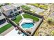 An aerial view of this home showcases a backyard oasis complete with a pool, grass and a play area at 4132 W Tunnel Mine Rd, New River, AZ 85087