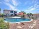 A backyard with pool, safety fence, patio umbrellas, artificial turf and gravel areas under sunny skies at 4132 W Tunnel Mine Rd, New River, AZ 85087
