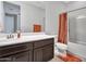 Bathroom features a dark wood vanity, ample counter space, and shower-tub combination at 4132 W Tunnel Mine Rd, New River, AZ 85087