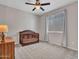 A carpeted Bedroom is staged with a wooden crib, dark wood dresser and window with vertical blinds and curtains at 4132 W Tunnel Mine Rd, New River, AZ 85087