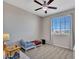 A carpeted room includes a ceiling fan, and a window with curtains and vertical blinds at 4132 W Tunnel Mine Rd, New River, AZ 85087