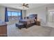 Bright bedroom featuring a ceiling fan and a large window with scenic desert views at 4132 W Tunnel Mine Rd, New River, AZ 85087