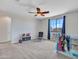A carpeted bedroom features a ceiling fan, a window with curtains and toys for a  at 4132 W Tunnel Mine Rd, New River, AZ 85087