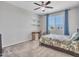 A carpeted bedroom features a ceiling fan, a window with blinds and curtains and a bed with patterned comforter at 4132 W Tunnel Mine Rd, New River, AZ 85087