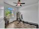 Bright bedroom features wood floors, an arched window, and a ceiling fan at 4132 W Tunnel Mine Rd, New River, AZ 85087