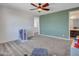 A carpeted bonus room includes a ceiling fan, neutral paint and a play area with a storage unit at 4132 W Tunnel Mine Rd, New River, AZ 85087