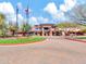 Spacious clubhouse with a well maintained landscape, circular drive, and flag poles flying the state and U.S. flags at 4132 W Tunnel Mine Rd, New River, AZ 85087