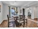 Inviting dining area is complete with wood floors, a table, and chairs at 4132 W Tunnel Mine Rd, New River, AZ 85087