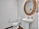 Charming half bath with pedestal sink, ornate mirror, and stylish fixtures and decor at 4132 W Tunnel Mine Rd, New River, AZ 85087