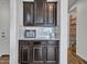 Kitchen features dark cabinets, granite counters and stainless steel appliances at 4132 W Tunnel Mine Rd, New River, AZ 85087