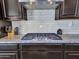Kitchen with granite counters, subway tile backsplash, and a modern stainless steel hood at 4132 W Tunnel Mine Rd, New River, AZ 85087