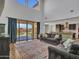 Bright, open living room with high ceilings, patio access, and seamless flow into a modern kitchen at 4132 W Tunnel Mine Rd, New River, AZ 85087