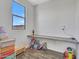 Bright playroom features wood floors, a window with blue sky views and fun, colorful decor and a desk at 4132 W Tunnel Mine Rd, New River, AZ 85087