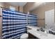 Bathroom features a shower/tub with stylish curtain, single vanity, and neutral decor at 4366 E Lexington Ave, Gilbert, AZ 85234