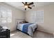 Well-lit bedroom with neutral walls, ceiling fan and window shutters at 4366 E Lexington Ave, Gilbert, AZ 85234