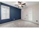 Bright, carpeted bedroom with blue accent wall, ceiling fan and bright window shutters at 4366 E Lexington Ave, Gilbert, AZ 85234