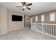 Spacious bonus room with plush carpeting, ceiling fan, and plenty of natural light at 4366 E Lexington Ave, Gilbert, AZ 85234