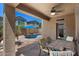 Relaxing covered patio featuring tiled flooring, ceiling fan, and view of the pool and backyard at 4366 E Lexington Ave, Gilbert, AZ 85234