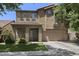 Inviting two-story home featuring a stone facade, a two-car garage, and a charming balcony, nestled in a tranquil neighborhood at 4366 E Lexington Ave, Gilbert, AZ 85234
