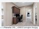 Functional home office space with built-in desk, upper cabinets and carpeted floor at 4366 E Lexington Ave, Gilbert, AZ 85234