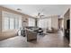 Bright and airy living room with tile floors, plantation shutters, and a ceiling fan, creating a cozy gathering space at 4366 E Lexington Ave, Gilbert, AZ 85234