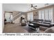 Spacious living room with neutral decor, tile flooring, and staircase at 4366 E Lexington Ave, Gilbert, AZ 85234
