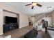 Open-concept living room featuring tile floors, neutral paint, a ceiling fan, and a staircase leading to the upper level at 4366 E Lexington Ave, Gilbert, AZ 85234