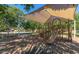 Community playground featuring covered play structure and mature trees offering shaded areas at 4366 E Lexington Ave, Gilbert, AZ 85234