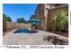 Inviting pool features custom stone design, lounge seating, and shade umbrella at 4366 E Lexington Ave, Gilbert, AZ 85234