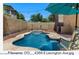 Beautiful pool features a waterfall, seating, and custom pool deck at 4366 E Lexington Ave, Gilbert, AZ 85234