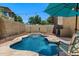 Inviting pool with a waterfall feature, surrounded by stone coping and lush landscaping at 4366 E Lexington Ave, Gilbert, AZ 85234