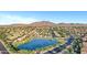 An aerial view of the community features a lake, mature landscaping, and mountain views at 4493 E Desert Sands Dr, Chandler, AZ 85249