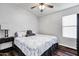 Bedroom with a large bed, laminate wood floors, and a dark wood night stand at 4493 E Desert Sands Dr, Chandler, AZ 85249