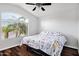 Bedroom featuring wood-look floors, a ceiling fan, a window and a queen-sized bed with nice linens at 4493 E Desert Sands Dr, Chandler, AZ 85249
