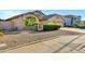 Charming single-story home featuring a well-manicured lawn, desert landscaping, and a spacious three-car garage at 4493 E Desert Sands Dr, Chandler, AZ 85249