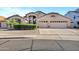 Charming single-story home featuring a well-manicured lawn, desert landscaping, and a spacious three-car garage at 4493 E Desert Sands Dr, Chandler, AZ 85249