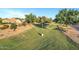 The community has a lush green parkway with walking paths and mature shade trees at 4493 E Desert Sands Dr, Chandler, AZ 85249