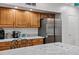 Kitchen close up featuring stainless steel refrigerator, granite counters and wooden cabinetry at 4493 E Desert Sands Dr, Chandler, AZ 85249