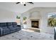 Bright living room features fireplace, tile floors, and a comfortable gray sofa at 4493 E Desert Sands Dr, Chandler, AZ 85249