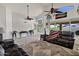 Spacious living room featuring vaulted ceilings, a ceiling fan, large windows, and comfortable seating at 4493 E Desert Sands Dr, Chandler, AZ 85249