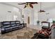 Open living room with high ceilings, ceiling fans, stylish decor, and comfortable seating arrangements at 4493 E Desert Sands Dr, Chandler, AZ 85249
