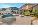 Inviting backyard pool area with mature tropical landscaping, and an umbrella for outdoor living at 4493 E Desert Sands Dr, Chandler, AZ 85249